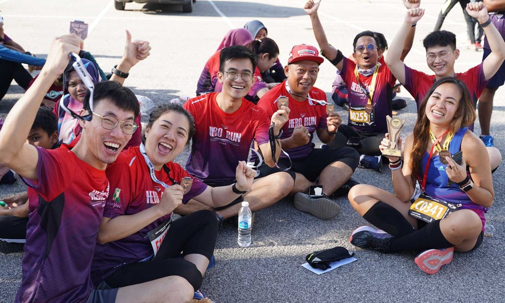 Finishers happy with their medal at Bukit Banyan Run